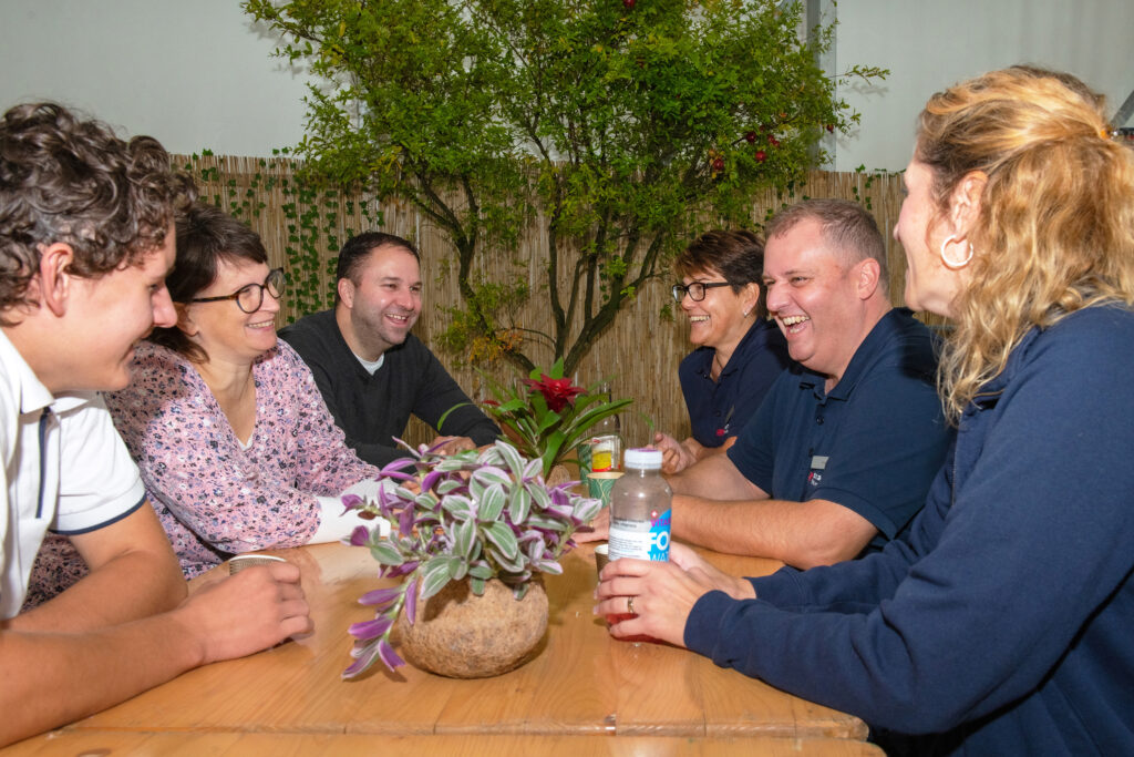 Samariter Mettmenstetten: Vereinsmitglieder sitzen zusammen an einem Tisch und lachen.